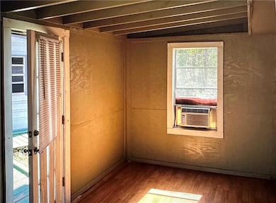 Spare room featuring wood finished floors