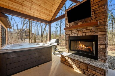 View of patio with area for grilling, an outdoor s