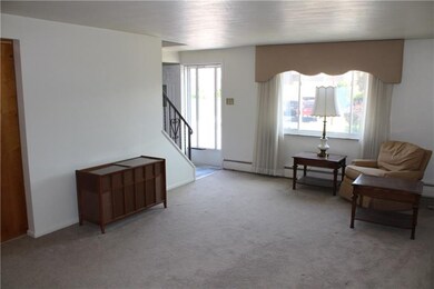Entry and stairway divide the living and dining ro