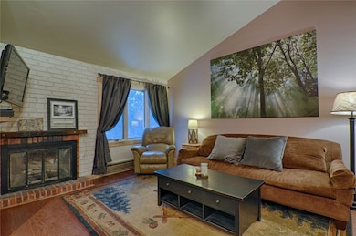 Living area with lofted ceiling, wood finished flo