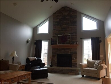 Great room features gas fireplace with stone accen