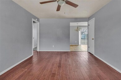 Empty room with ceiling fan with notable chandelie
