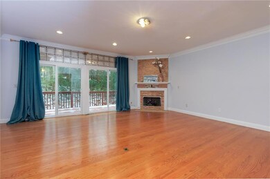 Unfurnished living room featuring crown molding, b