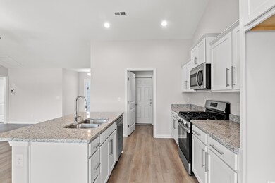 Kitchen featuring visible vents, a kitchen island 