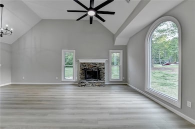 Unfurnished living room with ceiling fan with nota