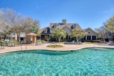 Community pool featuring a patio area and fence