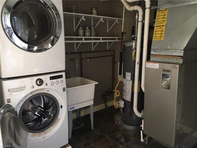 Laundry room with high effiency furnace.