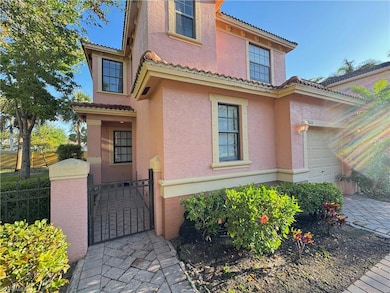 Doorway to property with stucco siding, a garage, 
