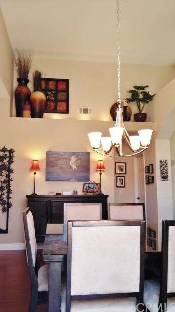 Formal dining with decorator lighting and architec