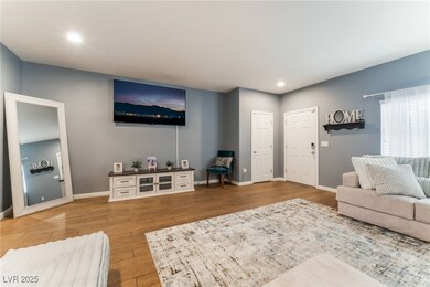 Living area with baseboards, wood finished floors,