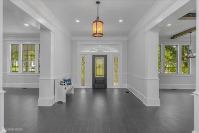 Entrance foyer featuring crown molding, a barn doo