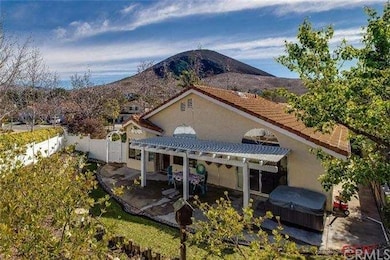 View of back yard which includes covered patio and