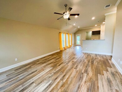 Unfurnished living room with ceiling fan, light hardwood / wood-style floors, crown molding