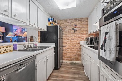 Kitchen featuring stainless steel appliances, whit