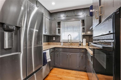 Kitchen with light stone countertops, stainless st
