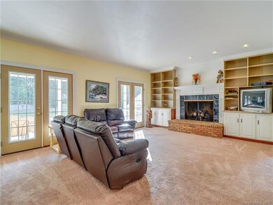 Family room overlooking patio, pool and expansive 