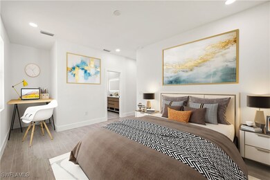Bedroom featuring wood finished floors, recessed l