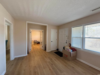 Interior space with a textured ceiling and light w
