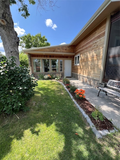 Entrance to property with a lawn