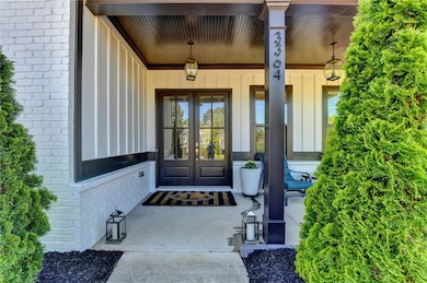 Property entrance featuring brick siding, a porch,