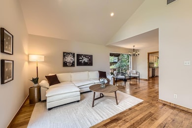 Living area featuring a chandelier, wood finished
