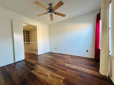 Unfurnished room featuring dark wood finished floors and ceiling fan