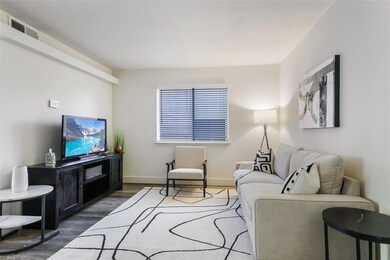 Living area with wood finished floors and baseboa