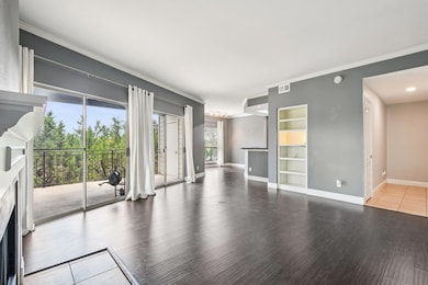 Unfurnished living room featuring a fireplace, wo