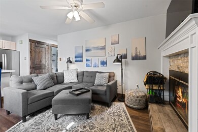 Living room with ceiling fan and hardwood / wood-s