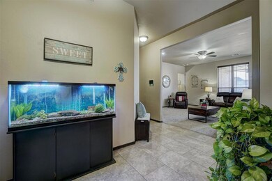 Living room featuring ceiling fan and light tile p