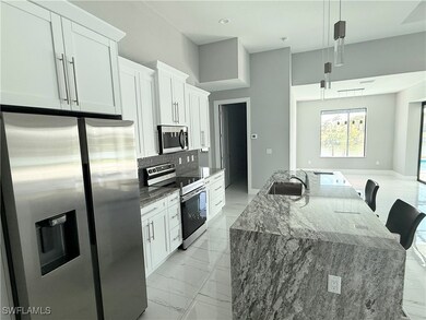 Kitchen featuring pendant lighting, white cabinetr