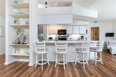 Kitchen bar open to Great Room with built-in shelv