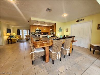 Dining space featuring light tile patterned floors