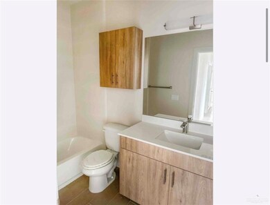 Bathroom with toilet, vanity, and a bath