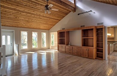 Unfurnished living room with visible vents, high v