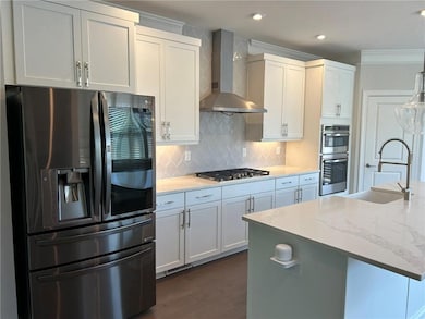 Kitchen with wall chimney range hood, tasteful bac