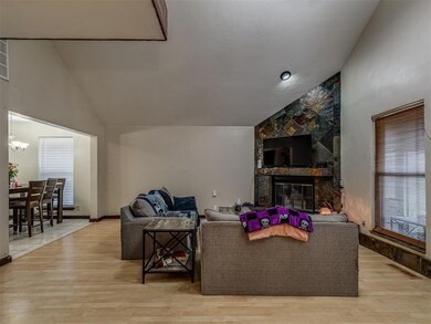 Tiled living room featuring high vaulted ceiling, 