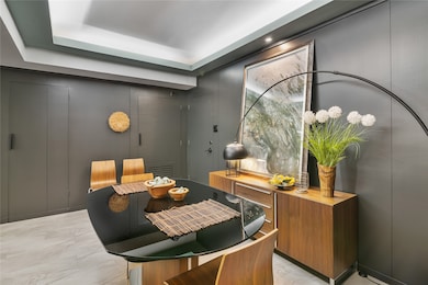 A black glass top table, mid-century chairs, and a