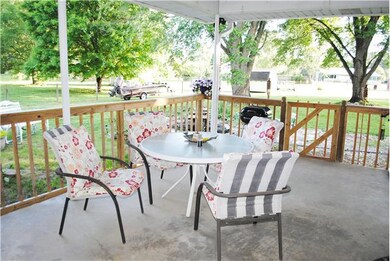 Carport currently being used as covered patio.  Fenced to keep animals in back yard during family gatherings.