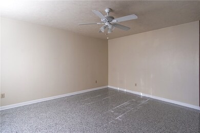 Spare room featuring a textured ceiling, dark spec