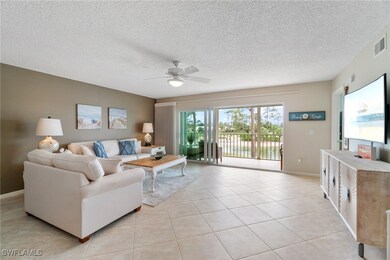 Living room with visible vents, a textured ceiling