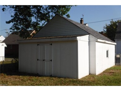 Attached storage shed behind garage