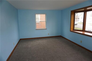 The Living Room features a bay window & wall-to-wa