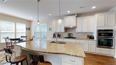 Modern white cabinets, gas cooktop with 5 burners,