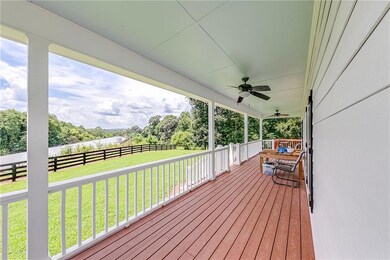 Wooden terrace with ceiling fan and a yard