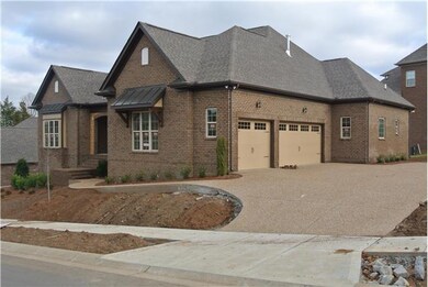 aggregate driveway with 3 car side entry garage