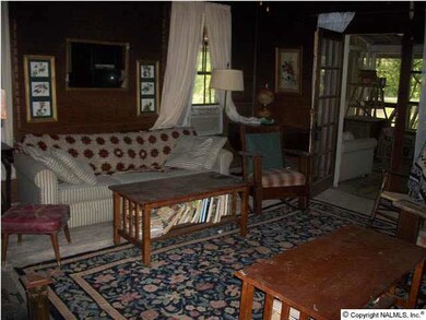 Living room looking toward french doors leading to front screened porch area.