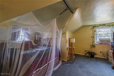 Bedroom with dark carpet and vaulted ceiling