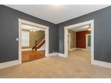 Living room with large doorways to foyer and forma