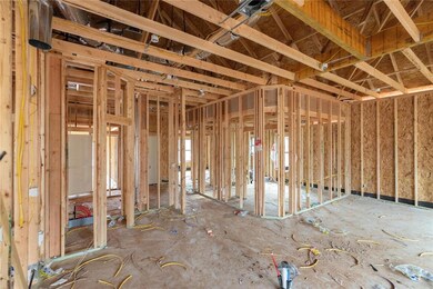 Unfurnished living room with wood finished floors and a glass covered fireplace